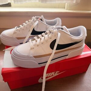 Nike Women's White and Black Sneakers with Gold Accents